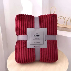 Detail of dark red flannel blanket with ribbed texture and grey ribbon gift packaging