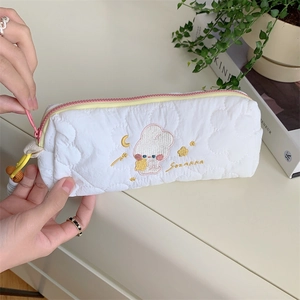 Close-up of cute rabbit embroidery on white daisy quilted stationery bag with pink zipper