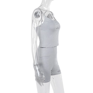 Close-up of grey elastic knit two-piece set with crop top and high waist shorts