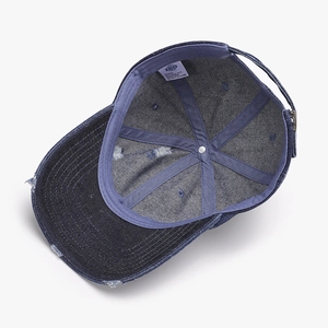 Distressed dark blue denim baseball cap with vintage ripped details and six-panel design