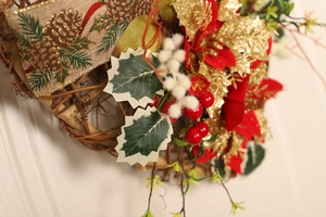 Detailed close-up of Christmas heart wreath with red poinsettia and burlap ribbon