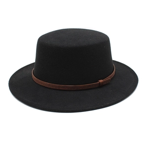 Détail d'un chapeau en laine noir avec bande en cuir tressé marron et motifs
