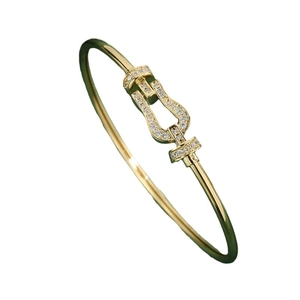 Luxury horseshoe buckle bracelet in gold and dark green with micro-pave cubic zirconia