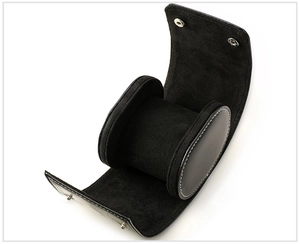 Detail of black leather watch roll showing internal pillows and secure snap closures