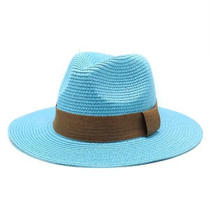 Close-up of sky blue straw Panama hat featuring a detailed brown ribbon band and woven texture