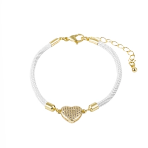 Macro detail of white braided rope bracelet with a gold heart pendant and lobster clasp