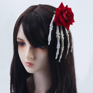 Gothic Halloween hair clip featuring a white skeleton hand holding a red rose on a model