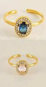 Detail of 18K gold-plated double-layer open rings with navy blue and pink gemstones