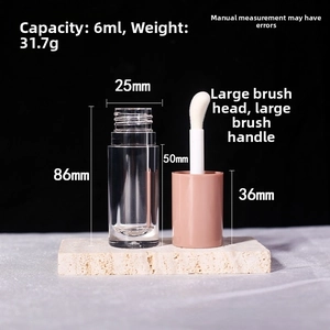Detailed view of 6ml clear lip gloss tube with pink cap and oversized flocking applicator