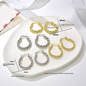 Detailed view of 18k gold and silver plated copper twisted hoop earrings in two sizes