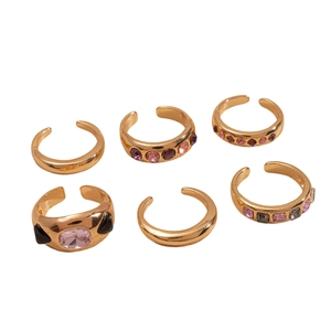 Set of 6 metallic geometric rings featuring rhinestones in gold, pink, and purple tones