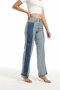 Detail of slim-fit low-waist jeans with contrast patchwork and frayed raw hem edges