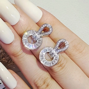 Macro shot of sparkling silver butterfly stud earrings with micro-inlaid zircons
