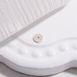 Macro detail of S925 sterling silver ultra-thin flat spacer beads for jewelry making