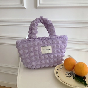 Detailed view of purple bubble texture canvas tote bag with Love Sozakka label on white desk