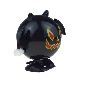 Detail showing wind-up knob and wings of a black Halloween bat clockwork toy