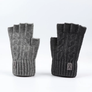 Close-up of gray knitted fingerless gloves with cable knit patterns and cuff labels