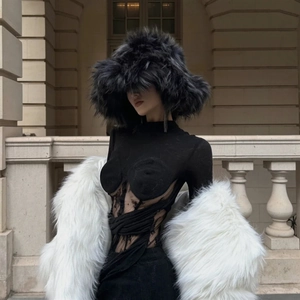 Close-up of black faux fur plush hat with white fur shawl against classic stone arches