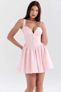 Detail of floral lace trim on pink gingham corset dress with deep V-neck and waisted fit