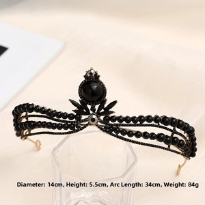 Close-up of a vintage black baroque tiara with gold frame, 14cm wide and 5.5cm tall