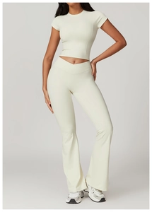 Detailed view of beige high-waisted flared yoga pants with a V-shaped crossover waist design