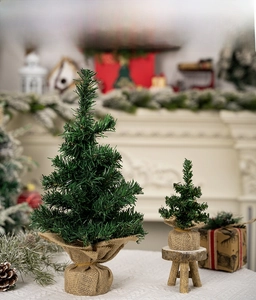 Close-up of mini artificial Christmas trees with burlap bases for tabletop decor
