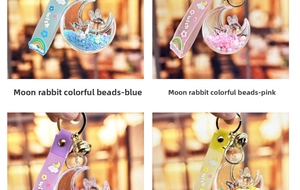 Close-up of creative moon rabbit liquid quicksand keychain with wish strap and metal bell