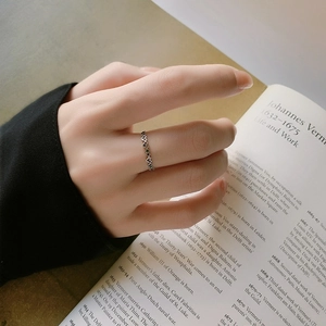 S925 silver vintage heart ring with green and black zircons on an artistic book background