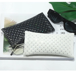 Detail of black and white diamond-stitched PU leather glasses pouches with rainbow sequins