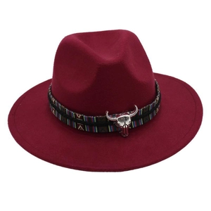 Detail of burgundy wool fedora featuring ethnic embroidery and silver bull skull buckle