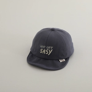 Detail shot of 3D embroidery on infant soft brim cotton cap in dark gray tone