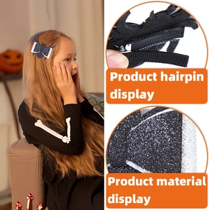 Detail of Halloween spider bow hair clip with black glitter finish and duckbill clip