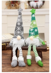 Detail of Christmas gnomes in grey and green knitted hats with snowflake embroidery