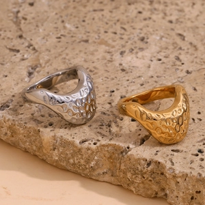 Detail of 18K gold and silver plated rings with irregular hammered organic texture