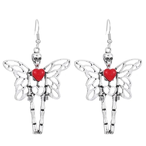 Detailed shot of gothic silver skeleton earrings with wings and red heart accents