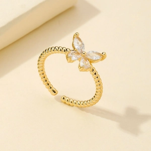 Elegant gold bow ring with marquise zircon stones and rope textured band design