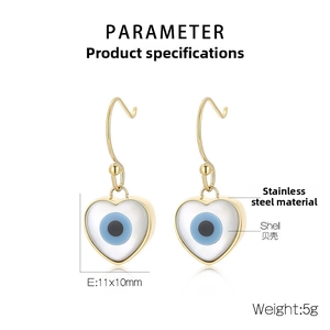 Detail of heart evil eye earrings made with shell inlay and golden stainless steel