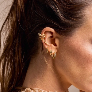 Golden snake-shaped ear cuff with twist texture hoop earrings for a stylish look