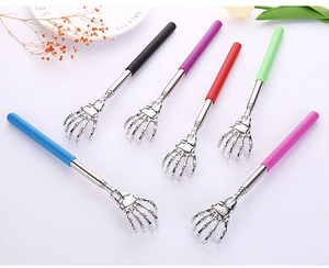 Detail of six colorful telescopic back scratchers with skeleton hand shaped metal tips