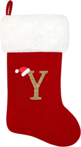 Detail of red Christmas stocking with golden glitter letter Y and festive hat
