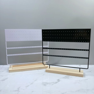 Detail of 144 holes earring display stand with wooden base in black and white colors