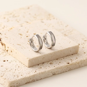 Macro view of S925 sterling silver hoop earrings with elegant mother of pearl inlay