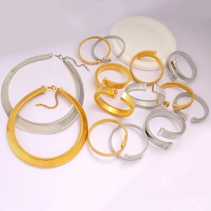 Elegant gold and silver twisted cable choker necklace and cuff bracelet jewelry set