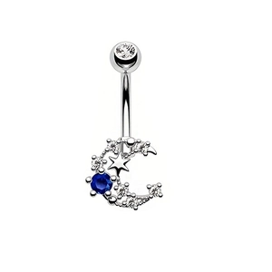 Detail of silver belly ring with blue gemstone, crescent moon and star pendant charms
