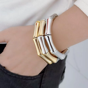 Elegant bamboo joint bracelet in polished gold and silver finish on a model wrist