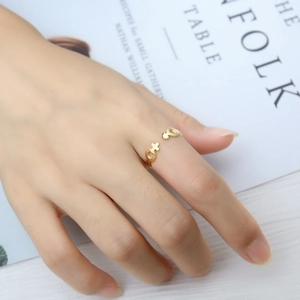 Close-up of gold adjustable ring featuring gender symbols on a lifestyle magazine
