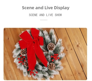 Detailed view of snowy pine needles with red bow and pine cones on wood background