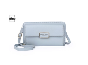 Detail view of light blue leather crossbody phone bag with gold metal plate and zipper