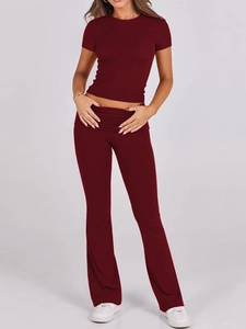 Women's burgundy two-piece sports set with cropped short sleeve top and flare trousers