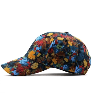 Detail of colorful maple leaf print on a classic curved brim baseball cap cotton fabric